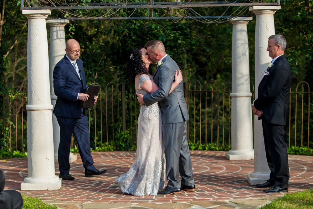 Bride and groom have their first kiss during their wedding ceremony at Senate's End in Columbia, SC