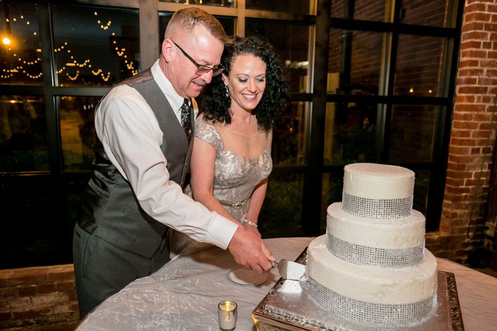 Bride and groom cut the cake during their reception at Senate's End in Columbia, SC