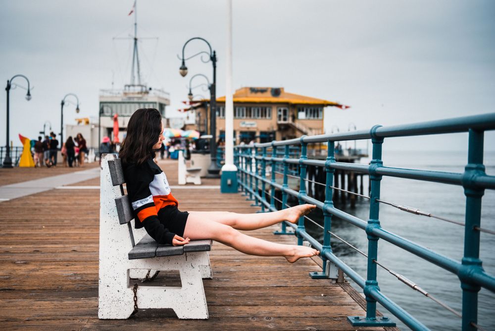 Girl pointing her toes while dancing for a photoshoot at Santa Monica Pier