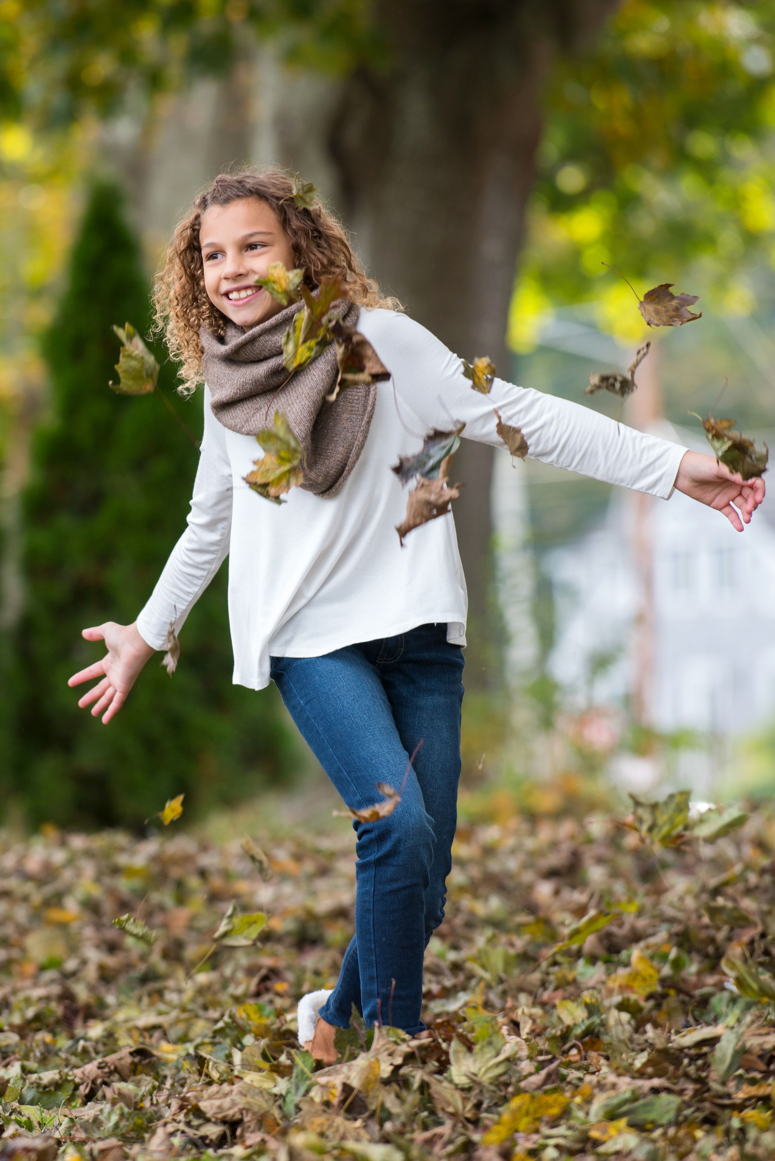 tween female model running through the leaves