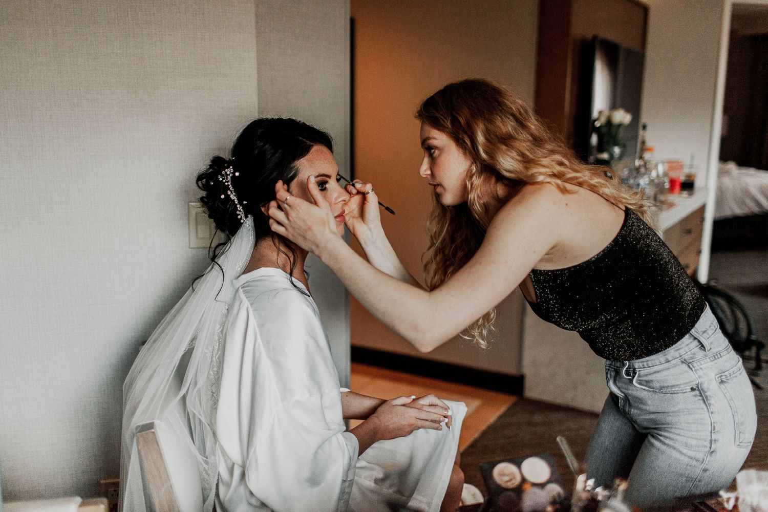 bride getting her makeup adjusted