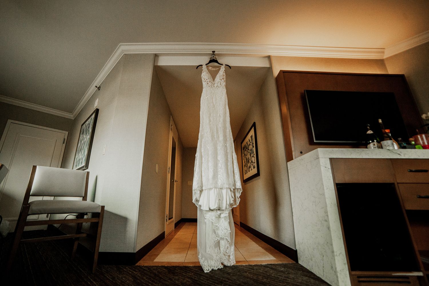 bride's wedding dress hanging in hotel