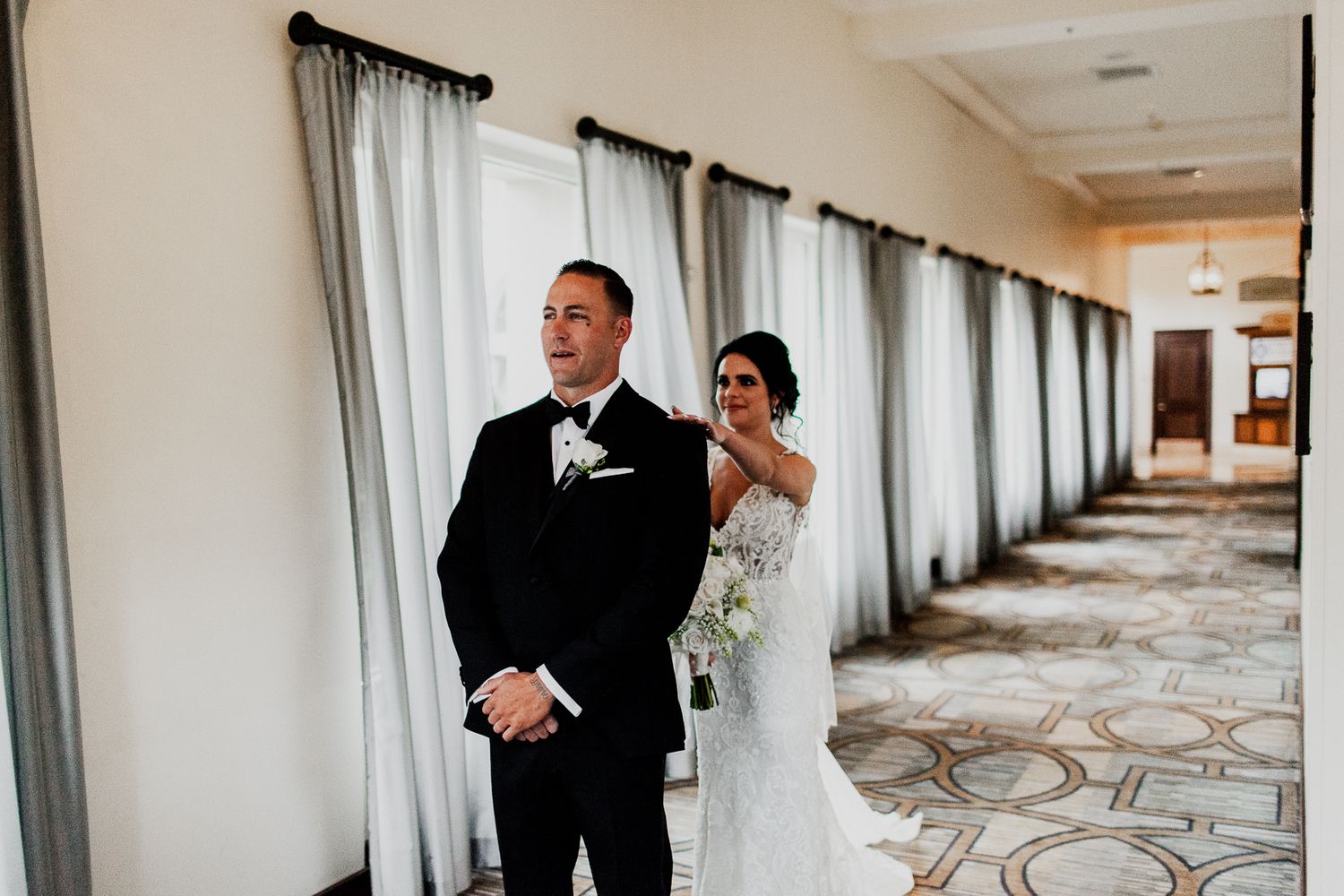 first look with bride and groom at hyatt regency hallway