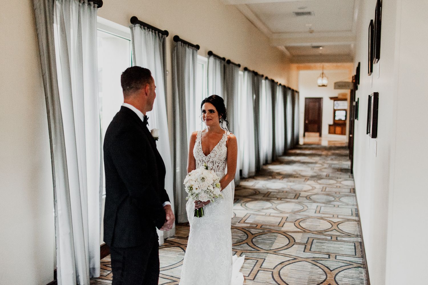 groom looking at bride in wedding dress