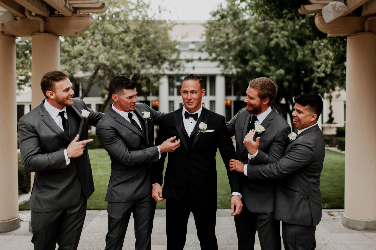 groomsmen candid congratulating groom