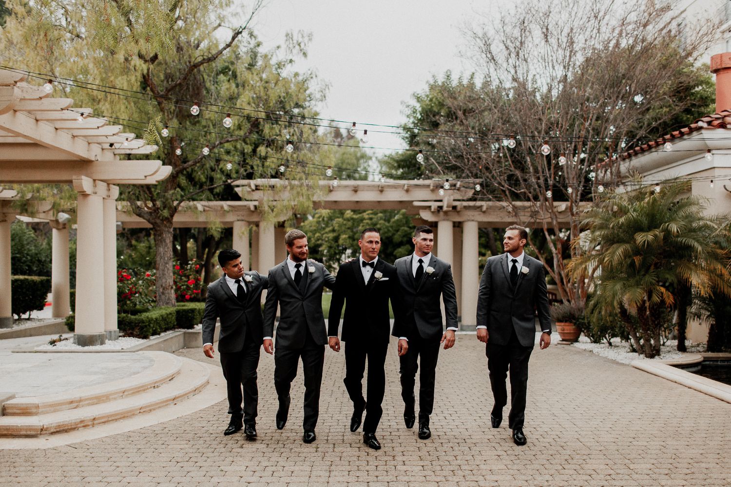 groom and groomsmen walking candid