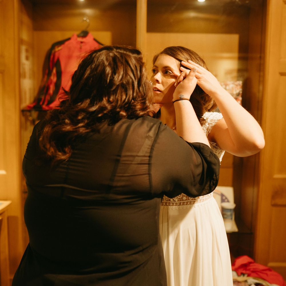bride-getting-makeup-on-wedding-cowles-library-desmoines-iowa-raelyn-ramey-photography