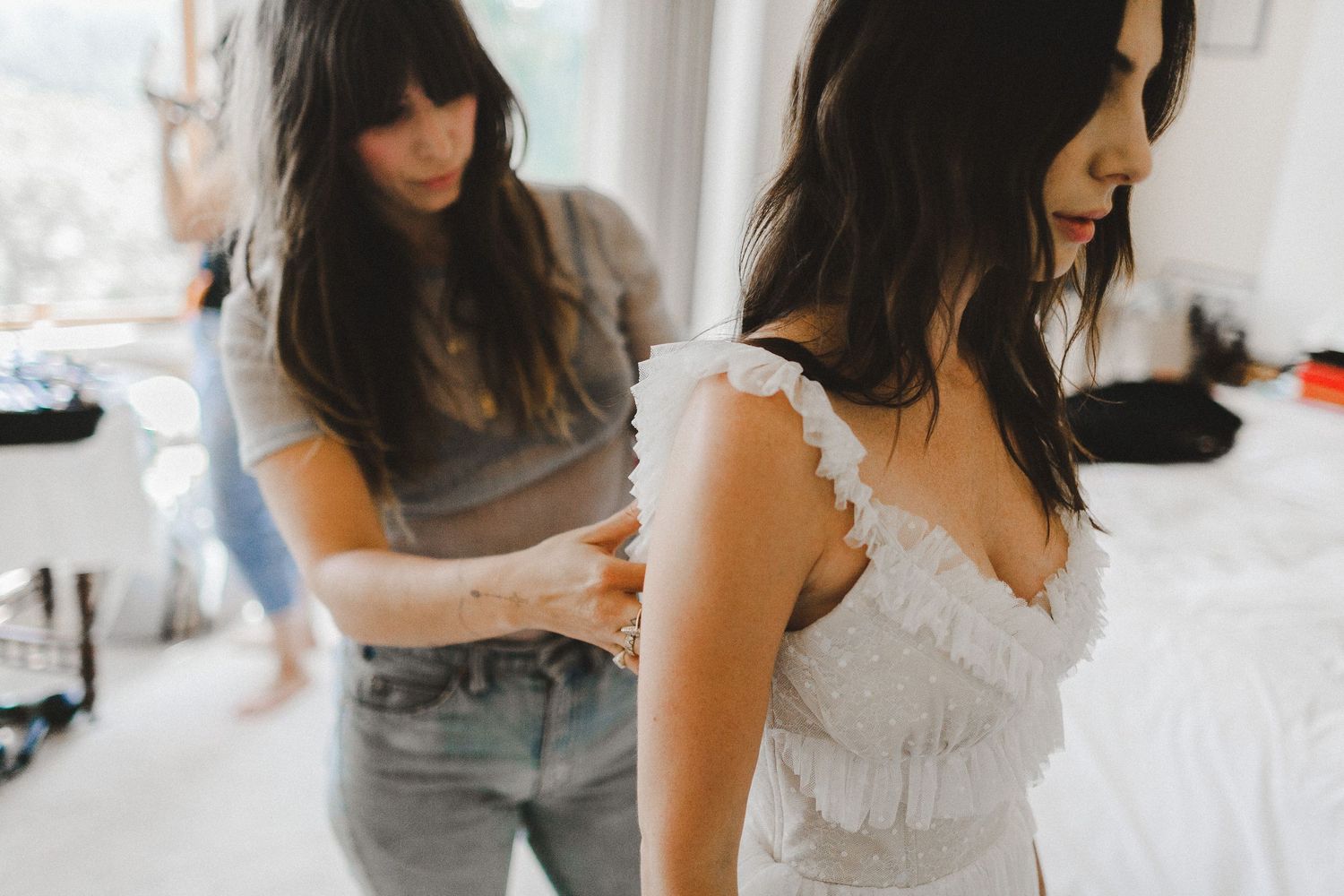 bride from different angle adjusting dress
