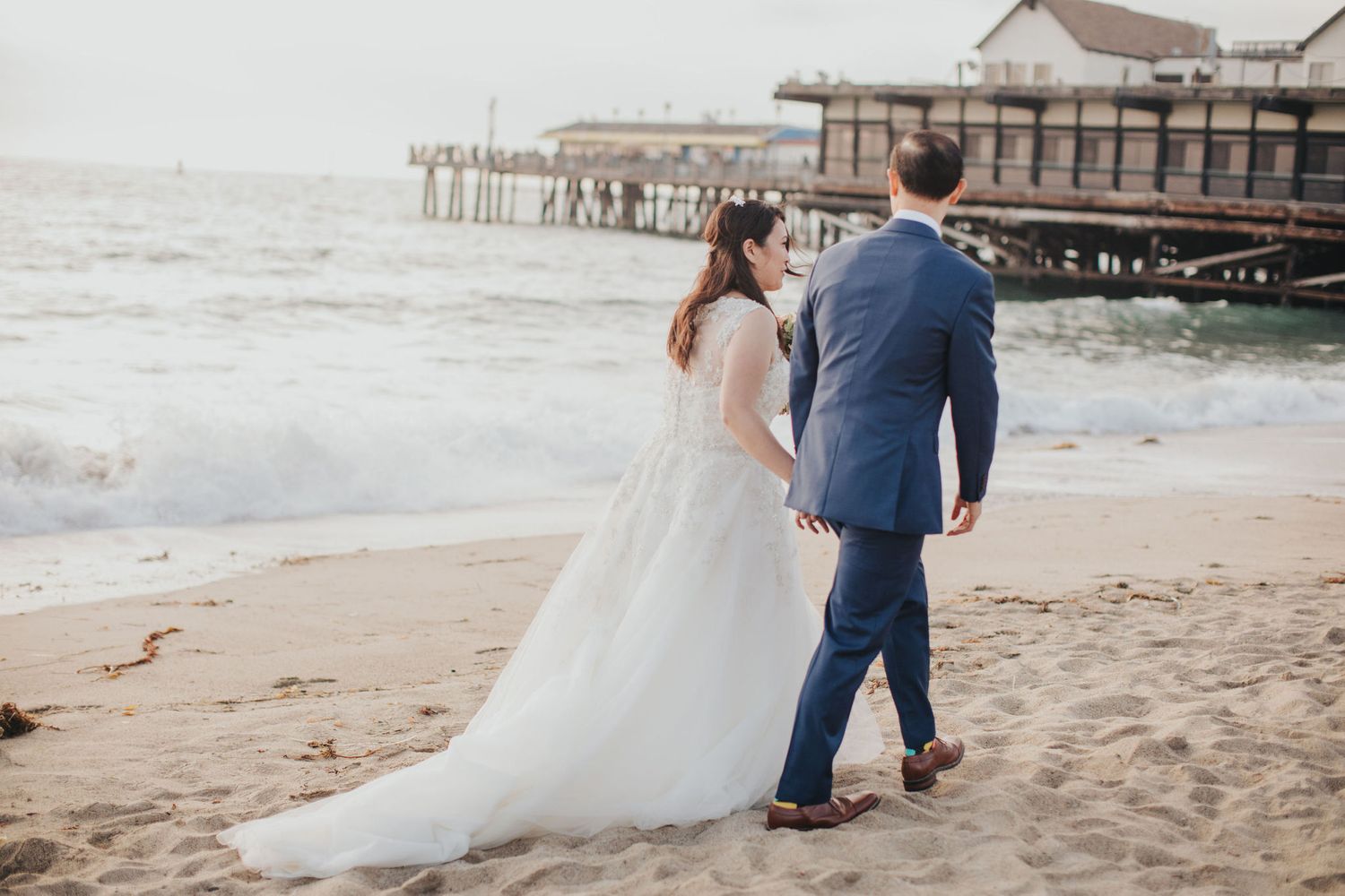 bride & groom walking on the beach