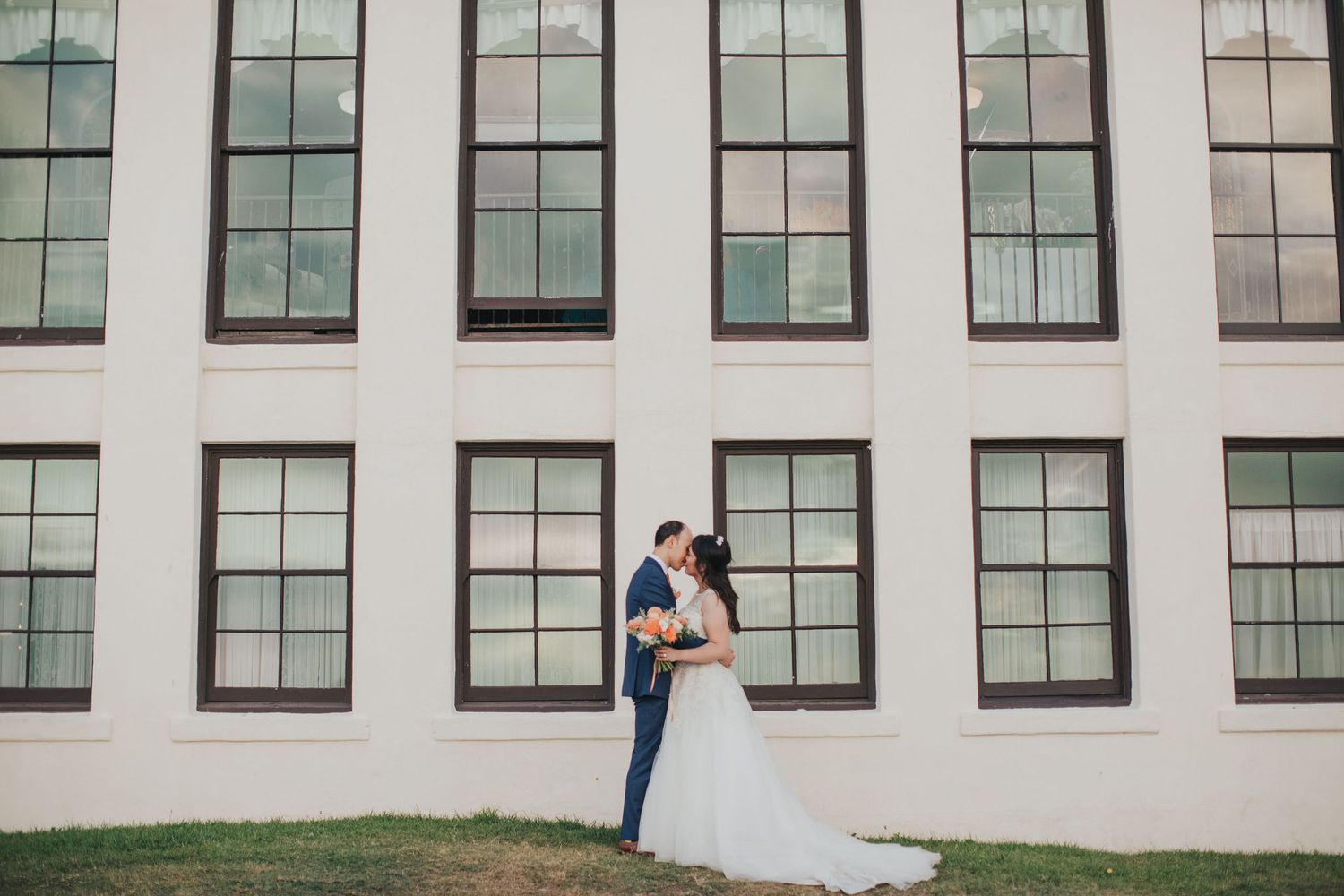bride & groom in front of windows redondo beach historic library