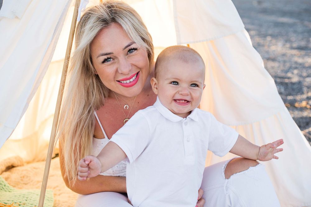 Baby smiling and mother looking at the camera