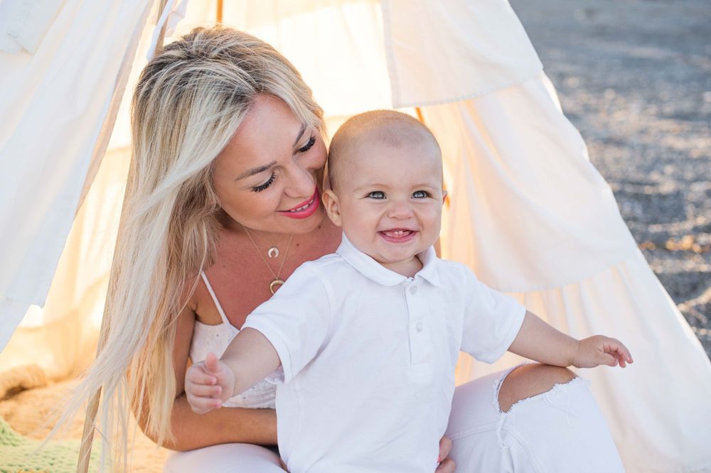 Portrait of a mom and baby boy holding hands