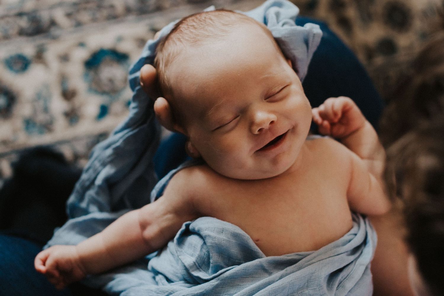 baby boy smiles while sleeping