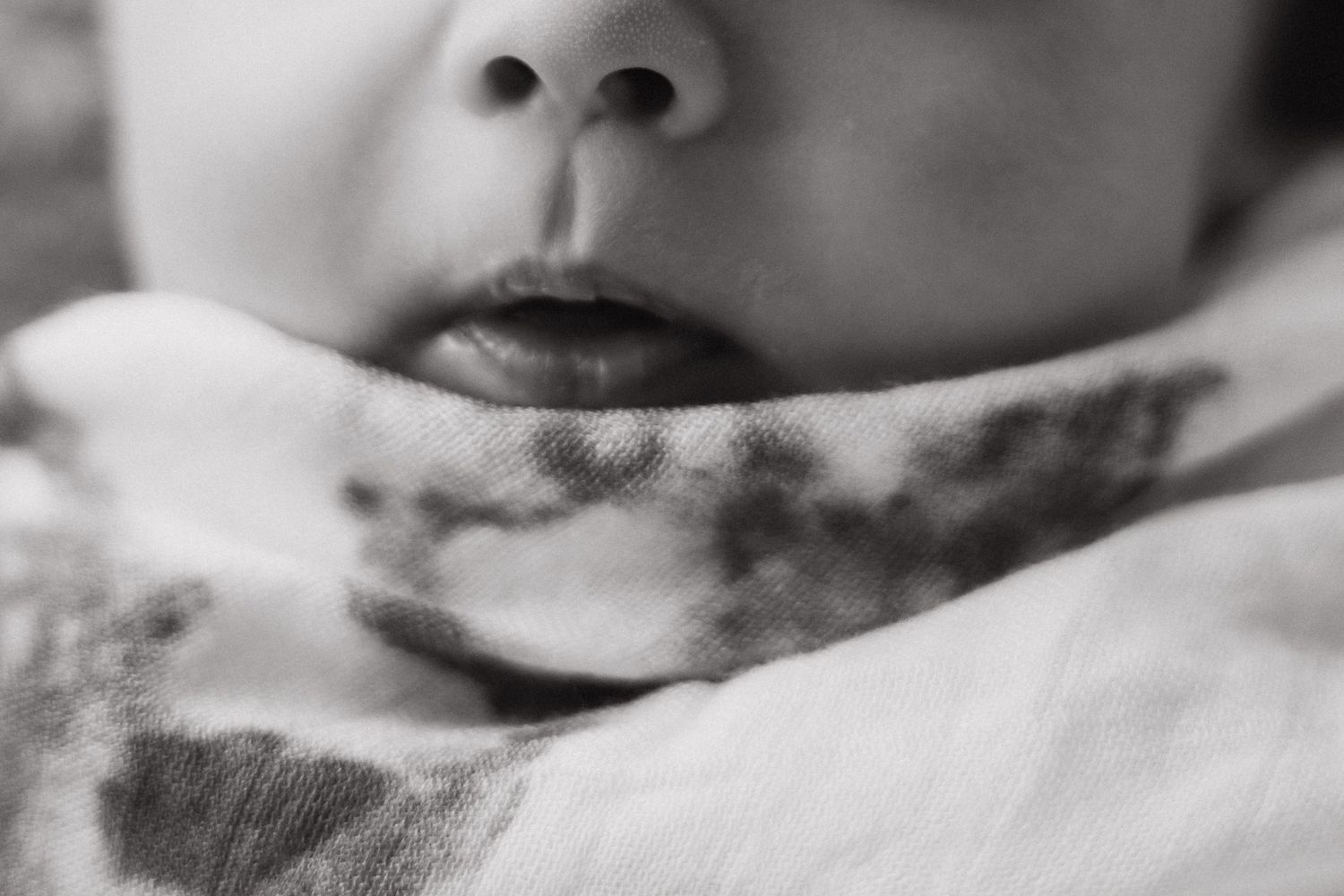black and white photo of newborn baby boy's lips