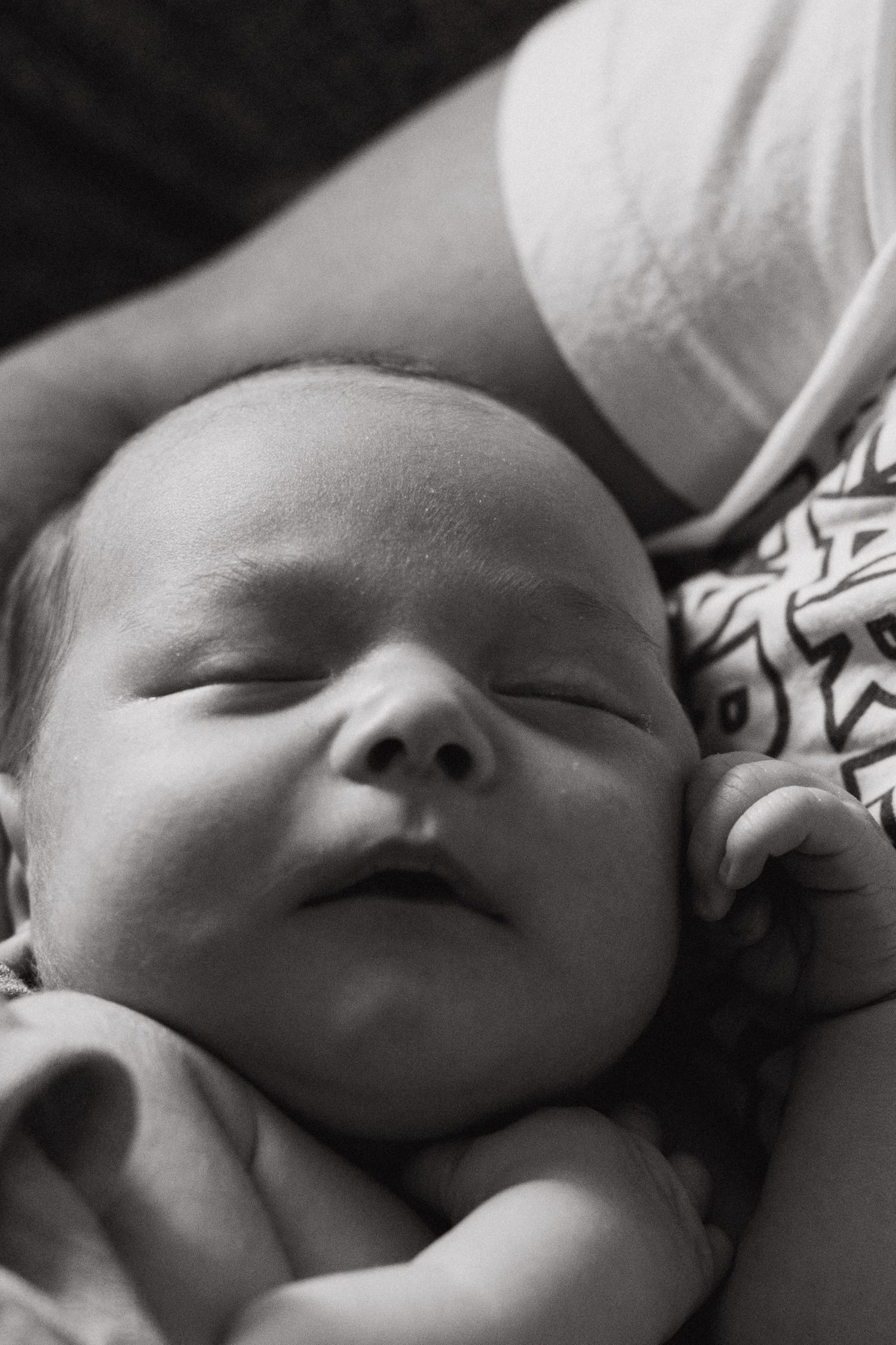 baby boy sleeps with hand near his face