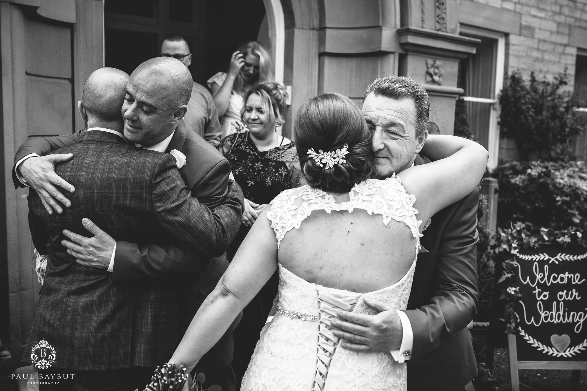 Father hugs the bride and is photographed by her Astely Bank Hotel wedding photographer