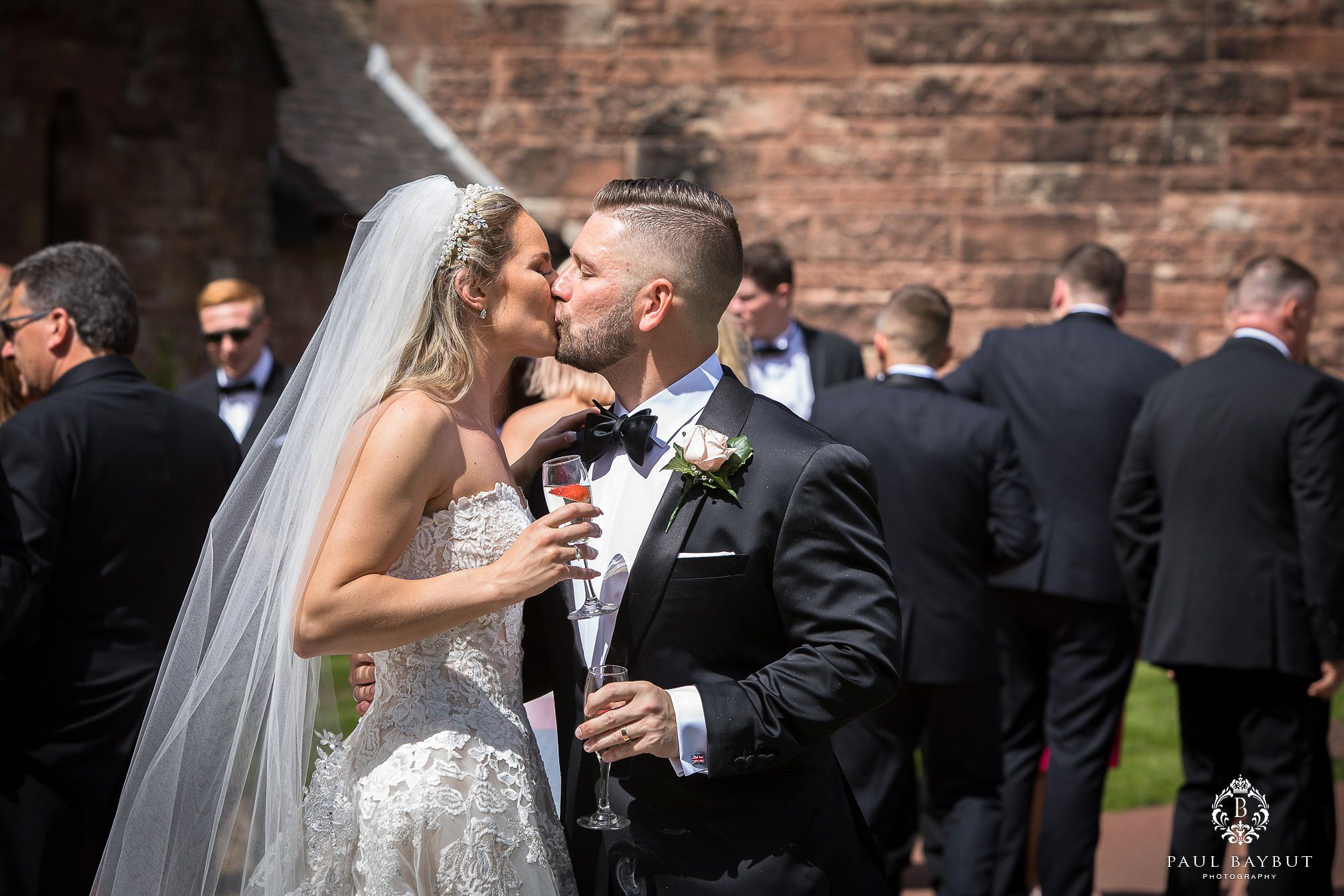 Bride and groom share a kiss at Peckforon castle during their first dance