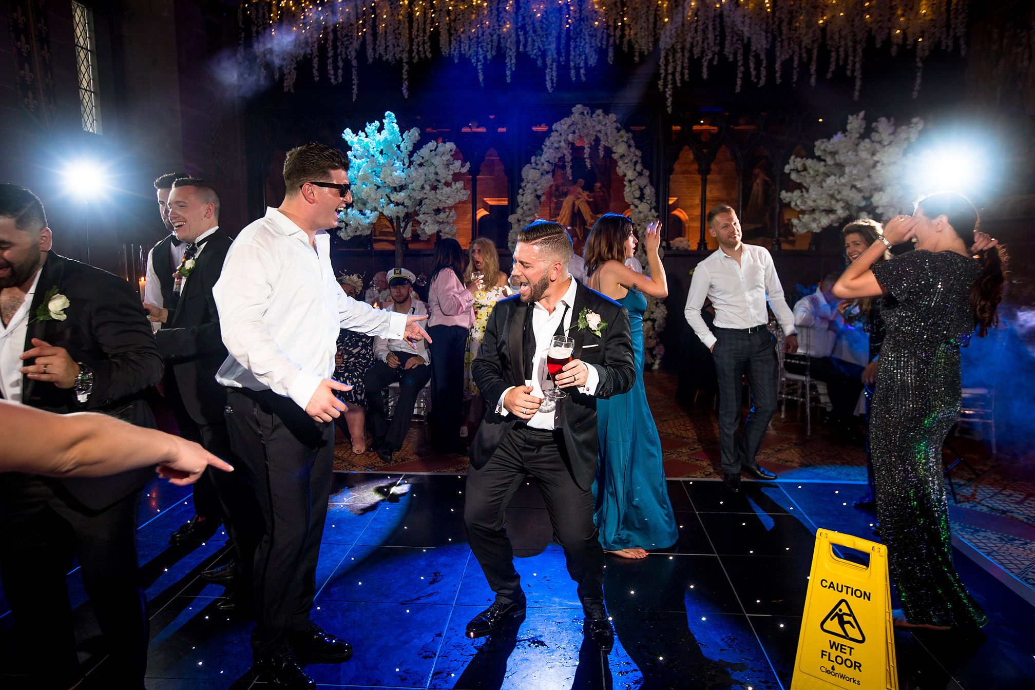 Groom dances on the dance floor at his Peckforton Castle wedding
