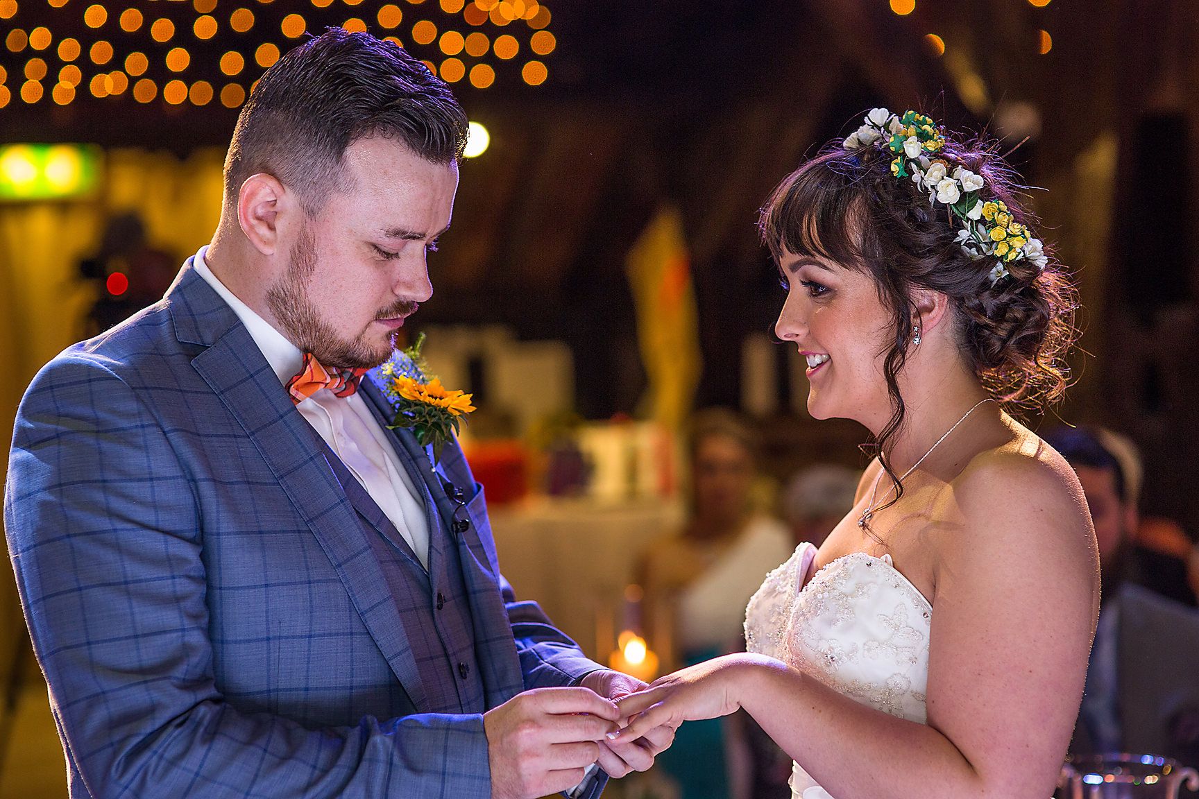 Groom places the ring on his brides finger during their Rivington barn wedding ceremony