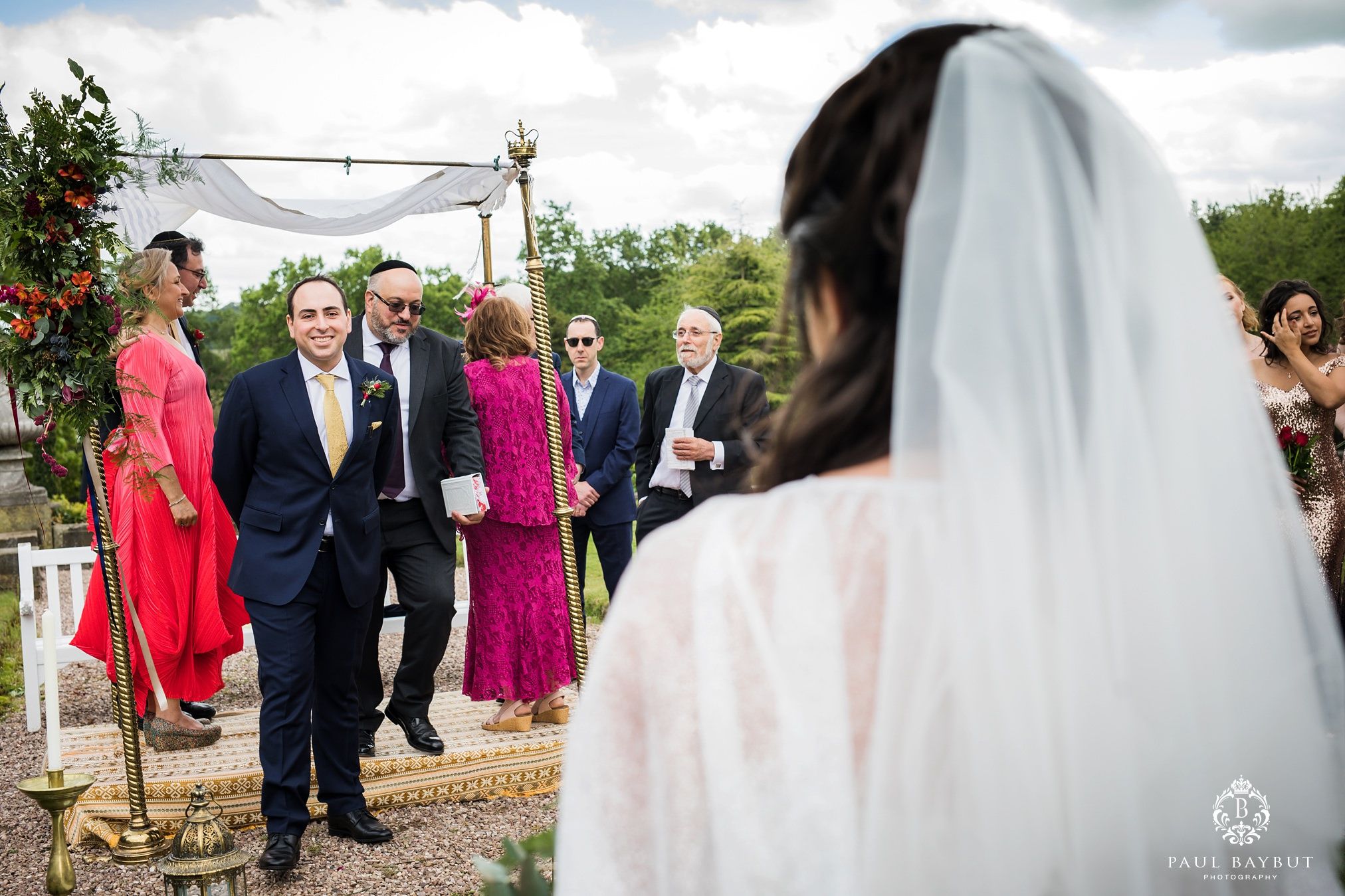 Jewish groom looks at his Persian bride in the gardens of their Tatton Park wedding