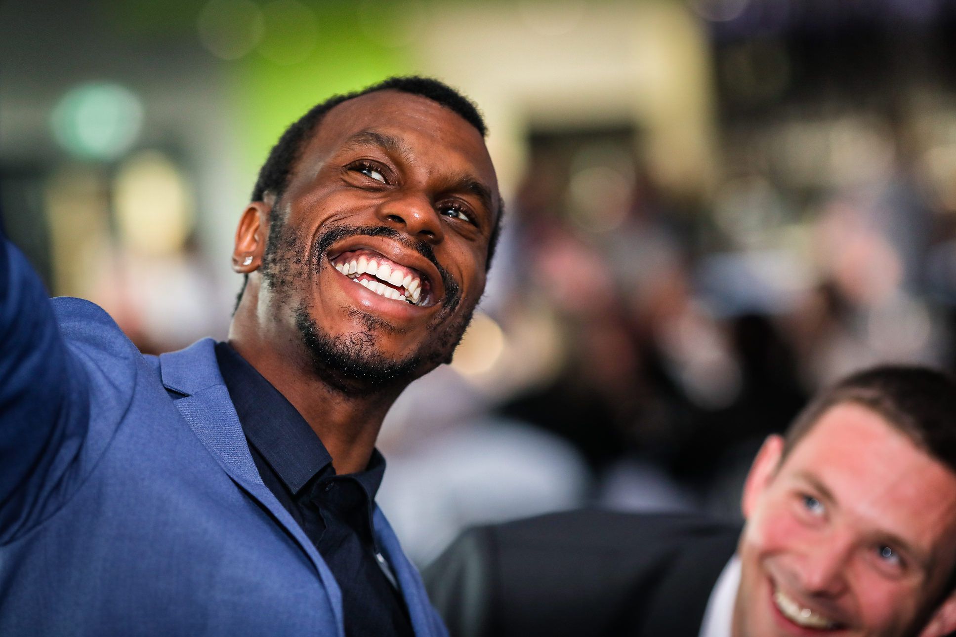 Town male wedding guests with big smiles take a selfie of themselves at The Lowry