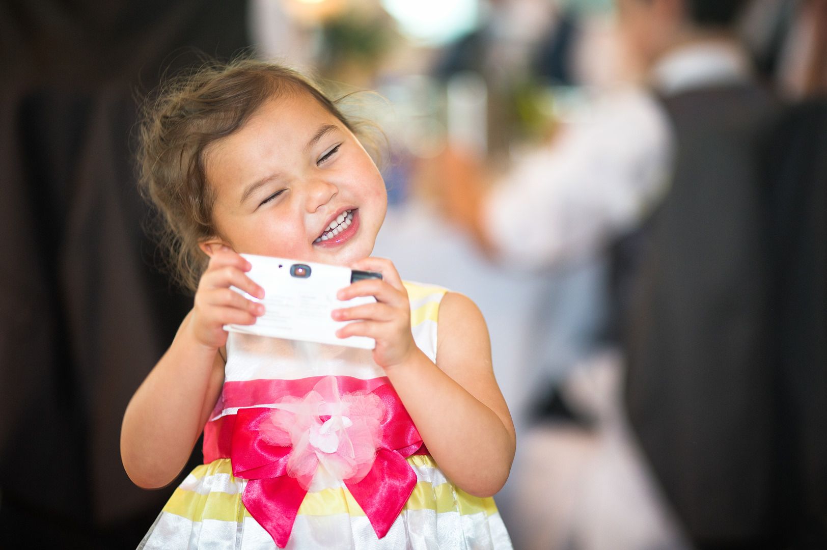 Cute little asian girl takes a photograph of Paul Baybut wedding photographer at The Lowry in Salford