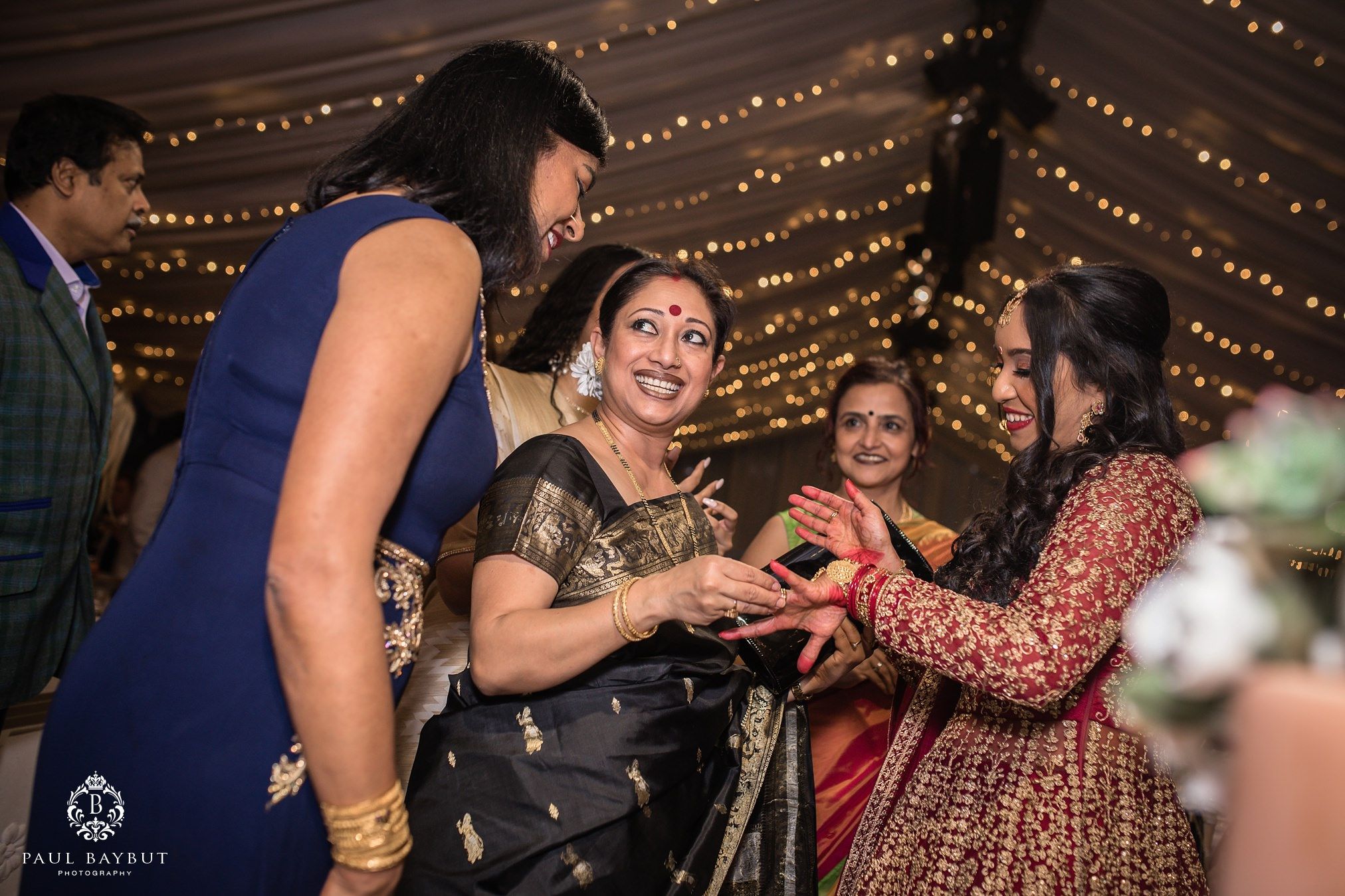 Indian wedding guests look at the brides ring inside the marquee at Thornton Manor
