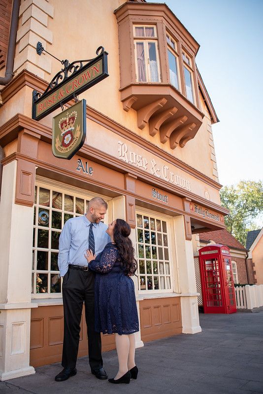 A couple standing in front of the Rose and Crown pub at the UK Pavilion at Walt Disney World's Epcot in Orlando FL