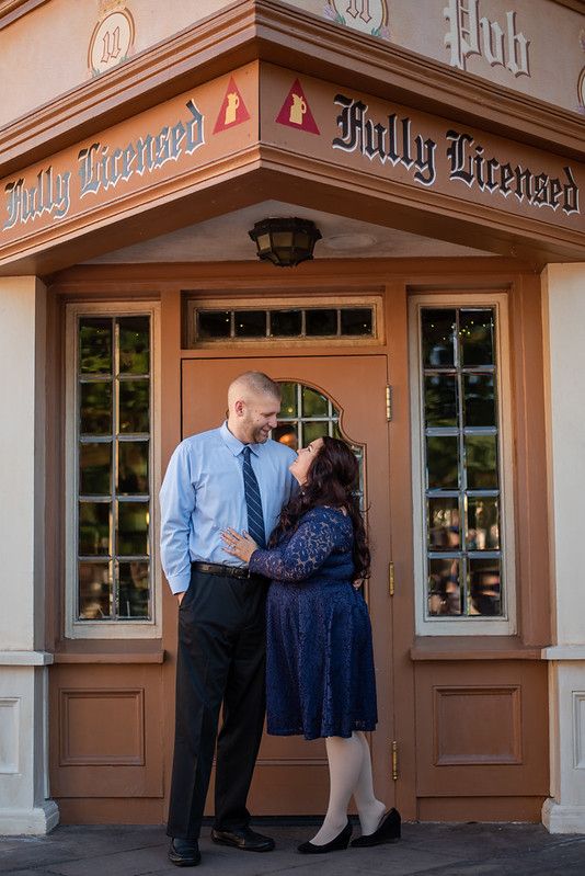 A couple standing in front of a pub door at the UK Pavilion at Walt Disney World's Epcot in Orlando FL