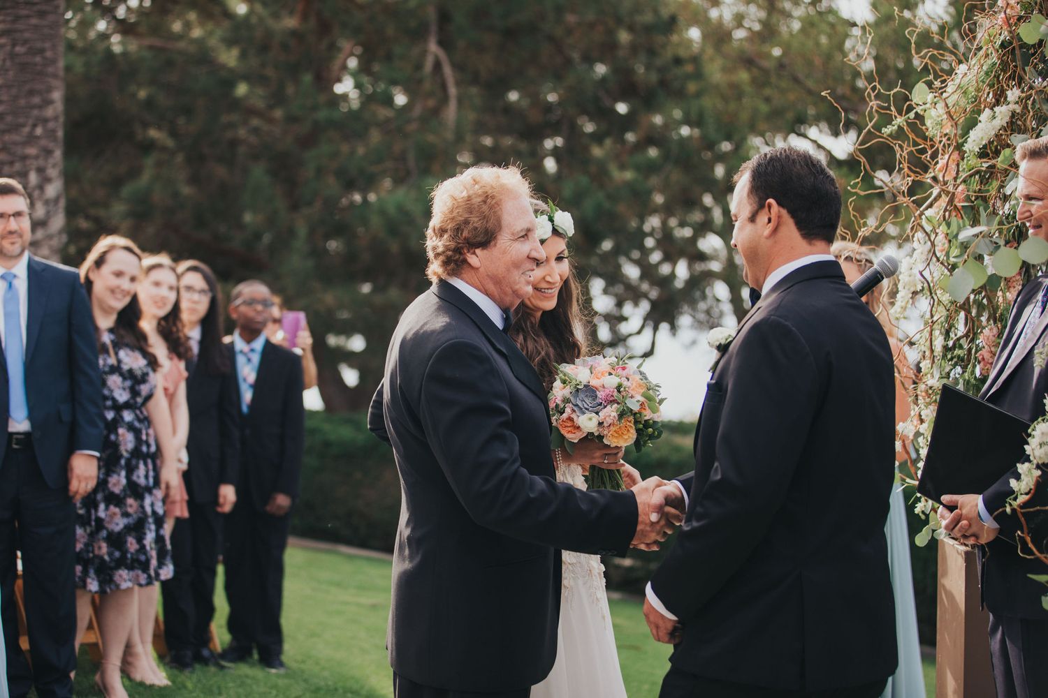 father shaking grooms hand