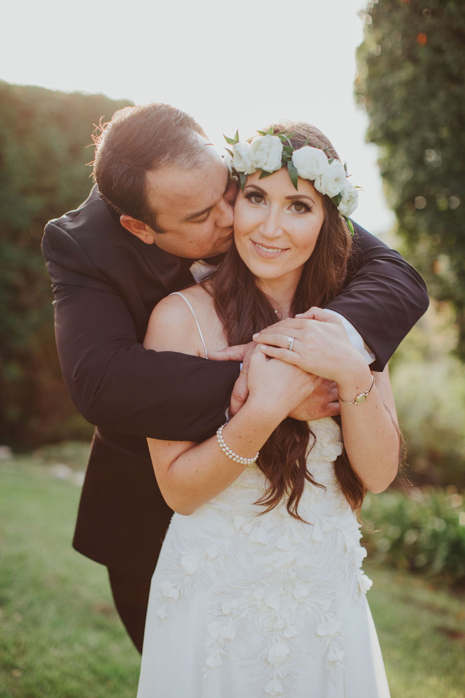 groom hugging bride from behind