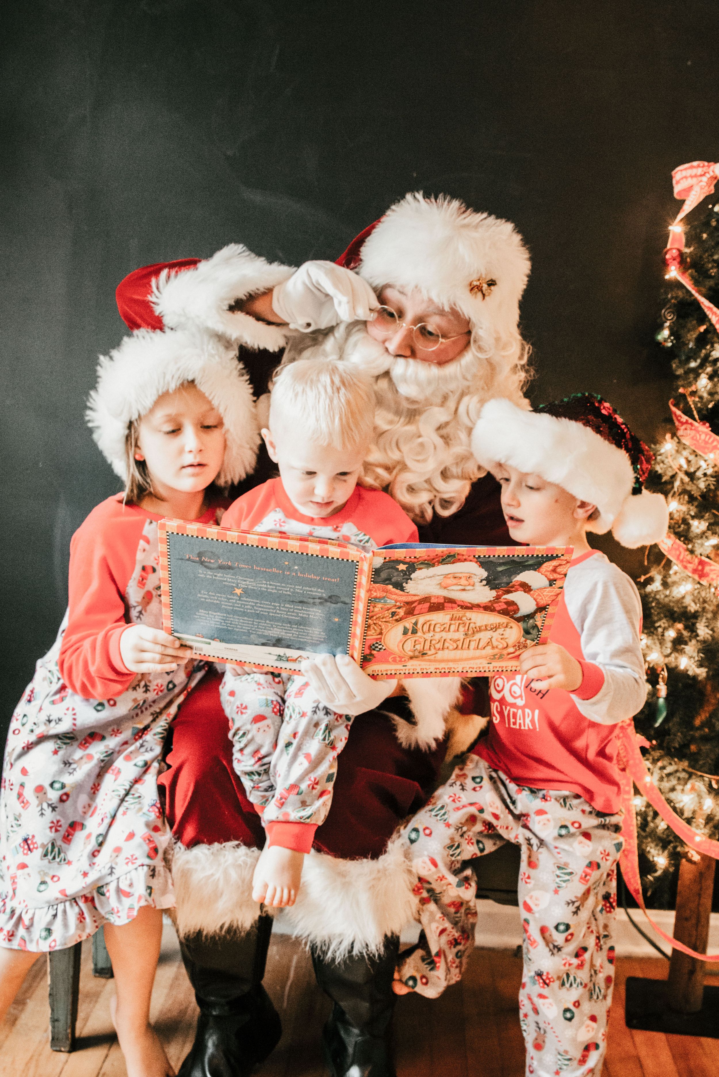 Santa reading to children in Christmas pajamas, Shiny Penny Studios, Cleveland