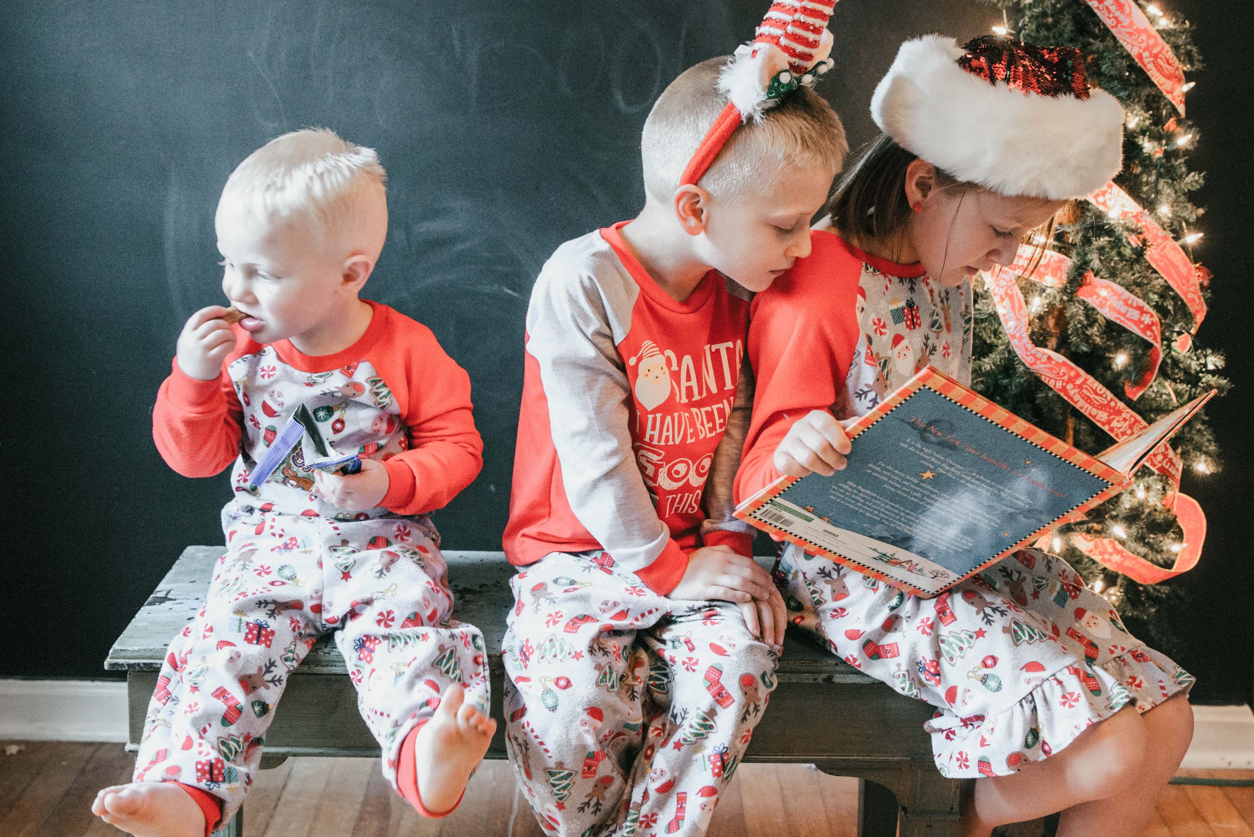 children reading book in Christmas pajamas, Shiny Penny Studios, Cleveland