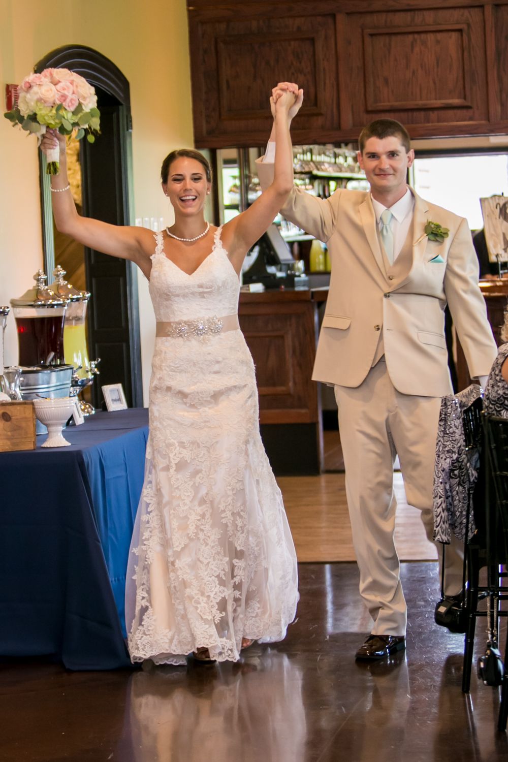 Bride Alex and groom Mike make their entrance at their wedding reception at Stone River in West Columbia, SC