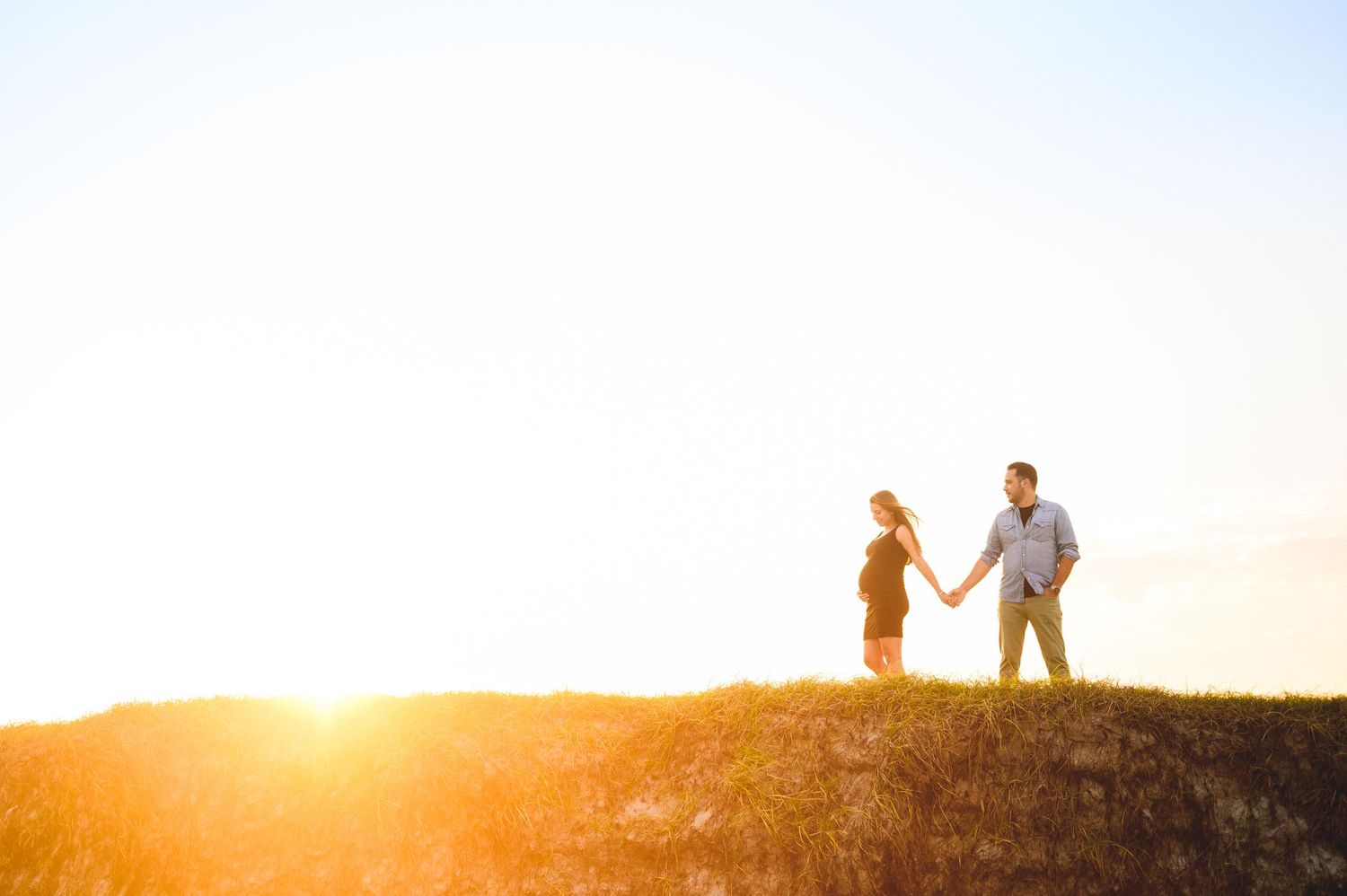 maternity couple on barnegat light beach during sunset