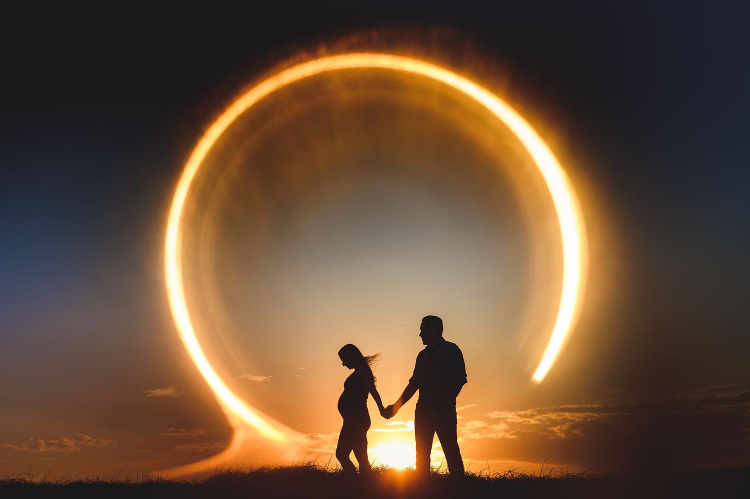 maternity couple on barnegat light beach during sunset