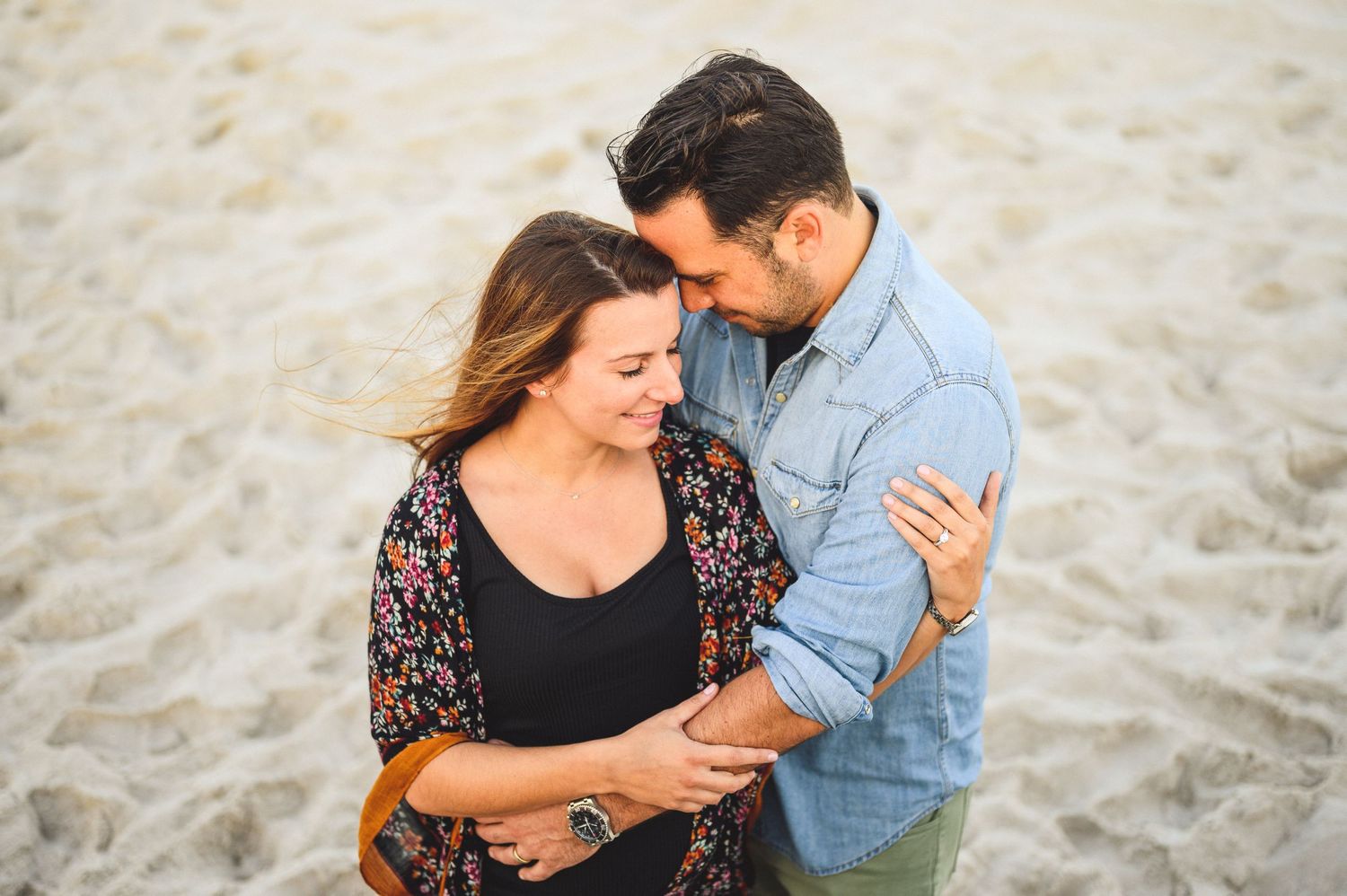maternity couple on barnegat light beach during sunset