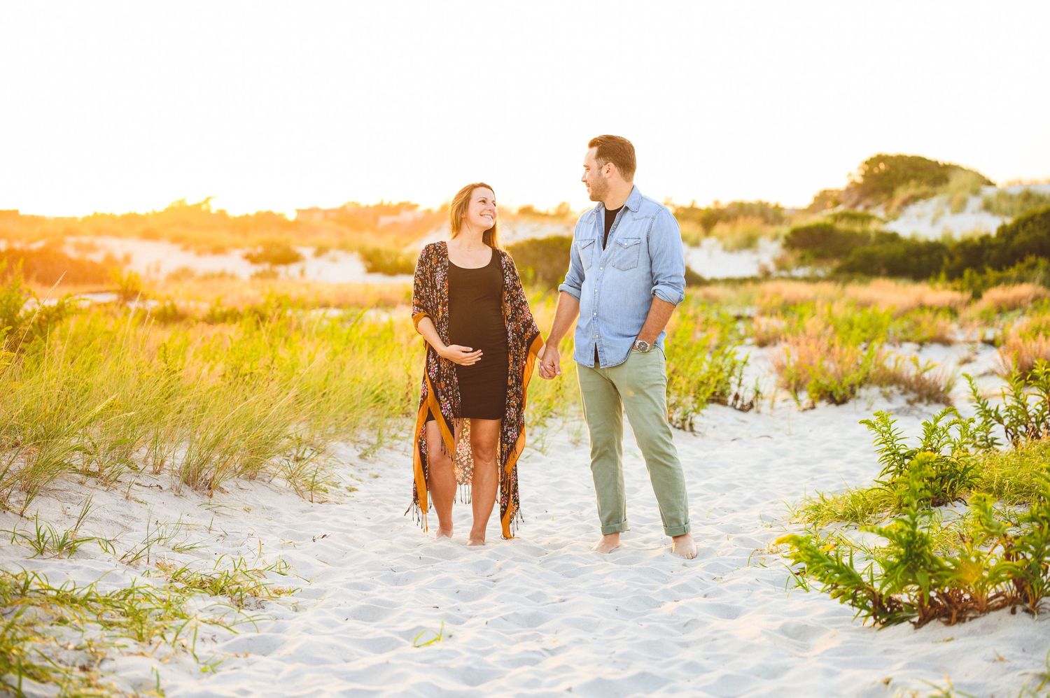 maternity couple on barnegat light beach during sunset