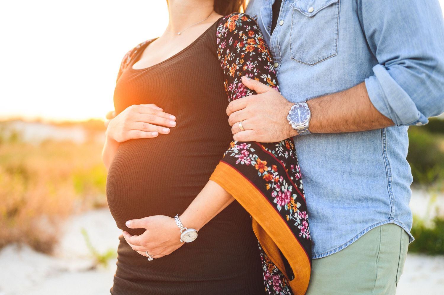maternity couple on barnegat light beach during sunset