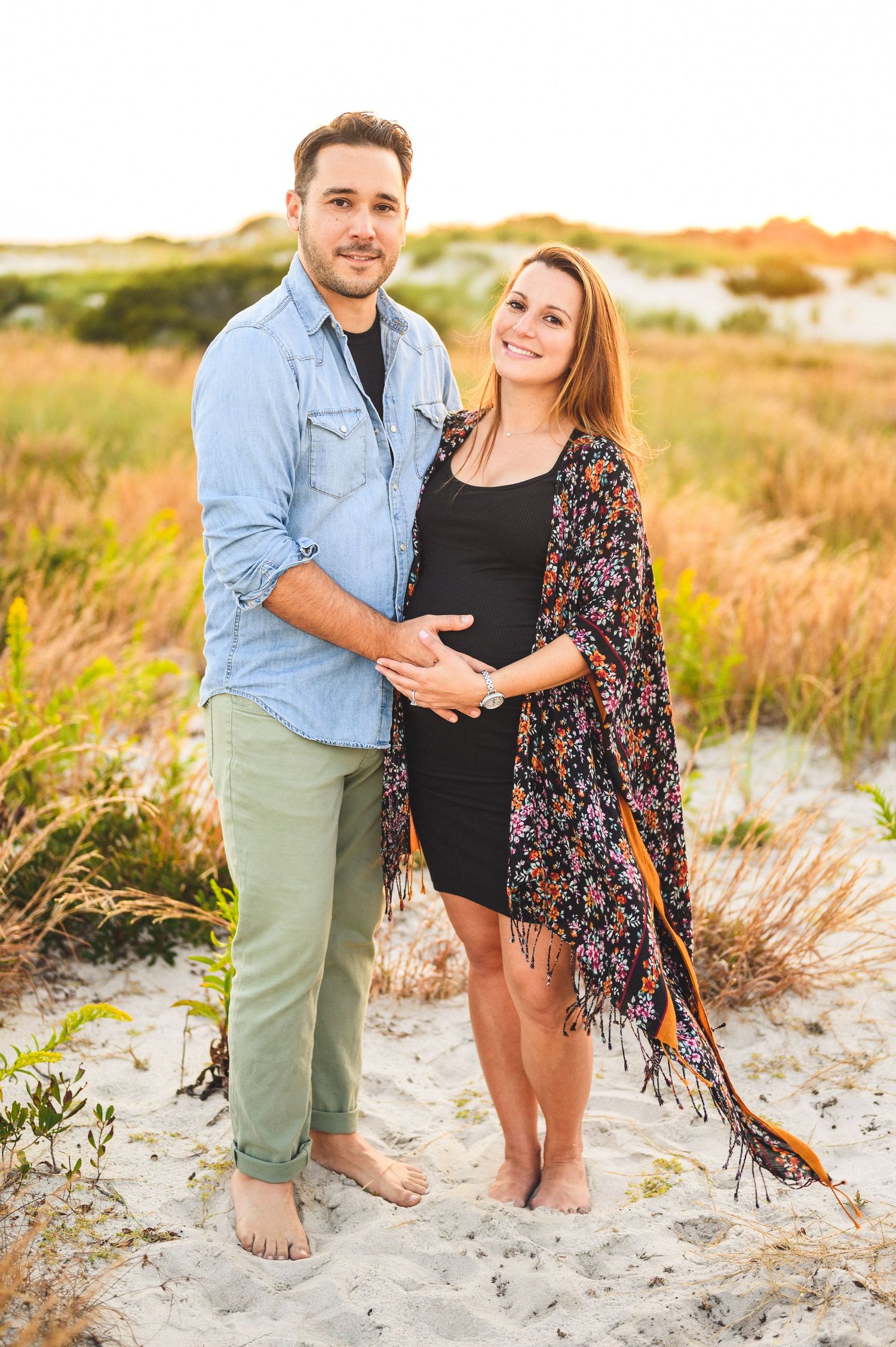 maternity couple on barnegat light beach during sunset