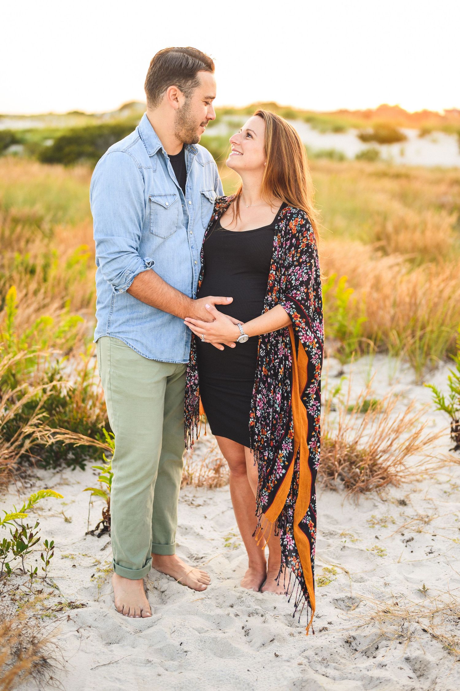 maternity couple on barnegat light beach during sunset