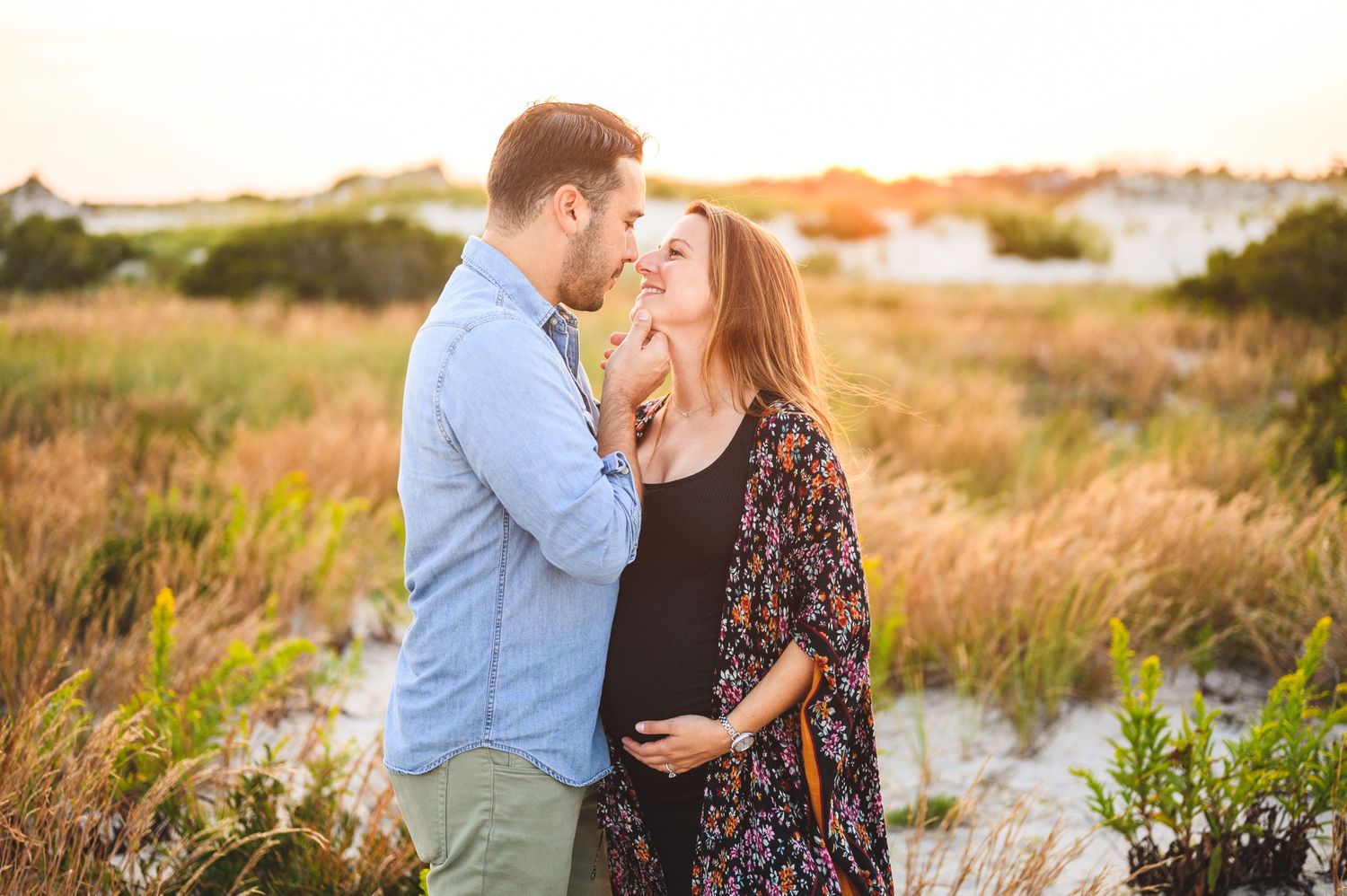 maternity couple on barnegat light beach during sunset