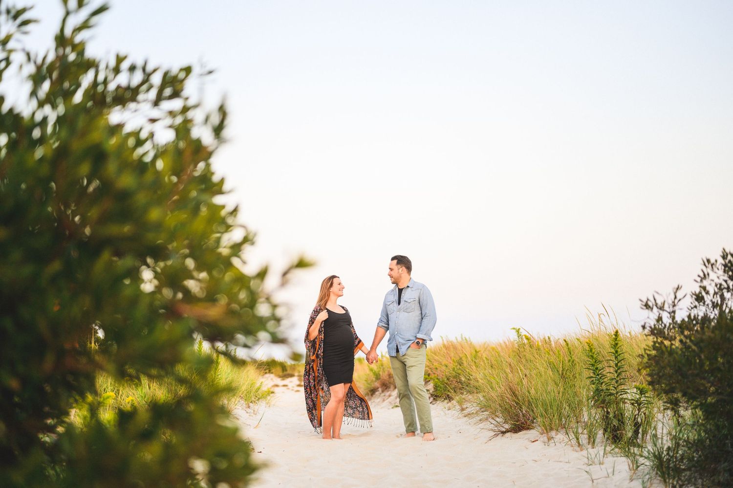 maternity couple on barnegat light beach during sunset