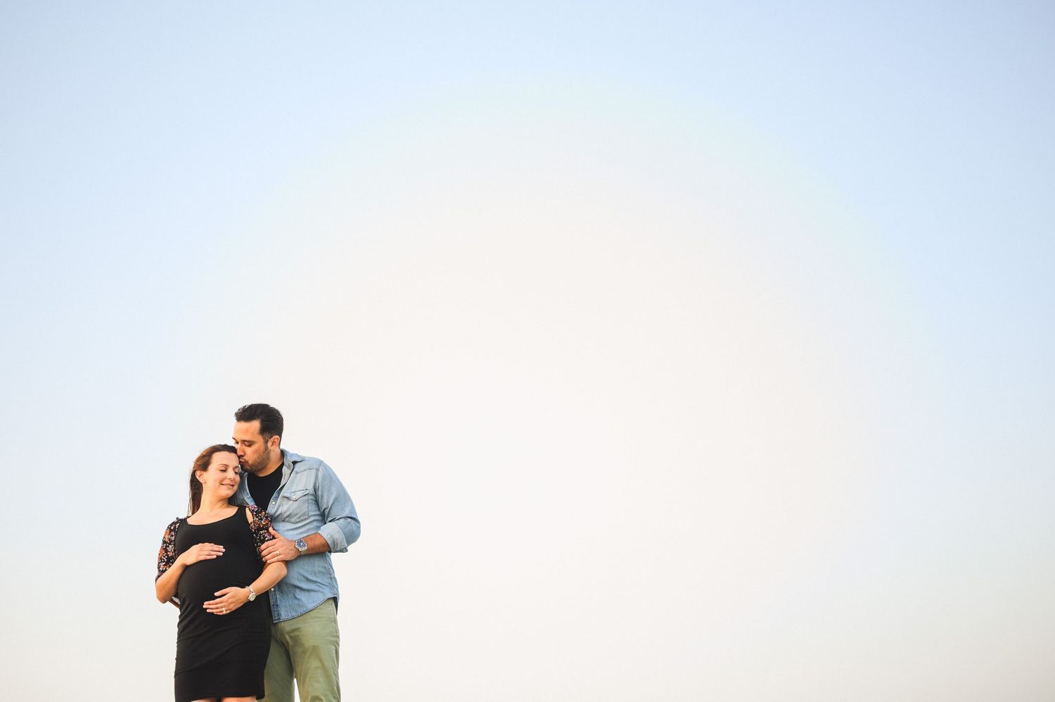maternity couple on barnegat light beach during sunset