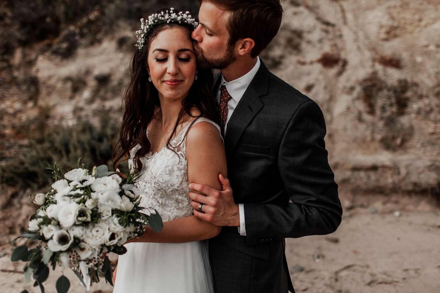 bride and groom as groom kisses bride