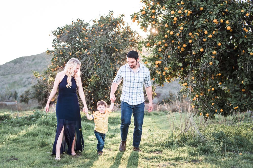 A photo of a family in an open field in San Juan Capistrano, CA
