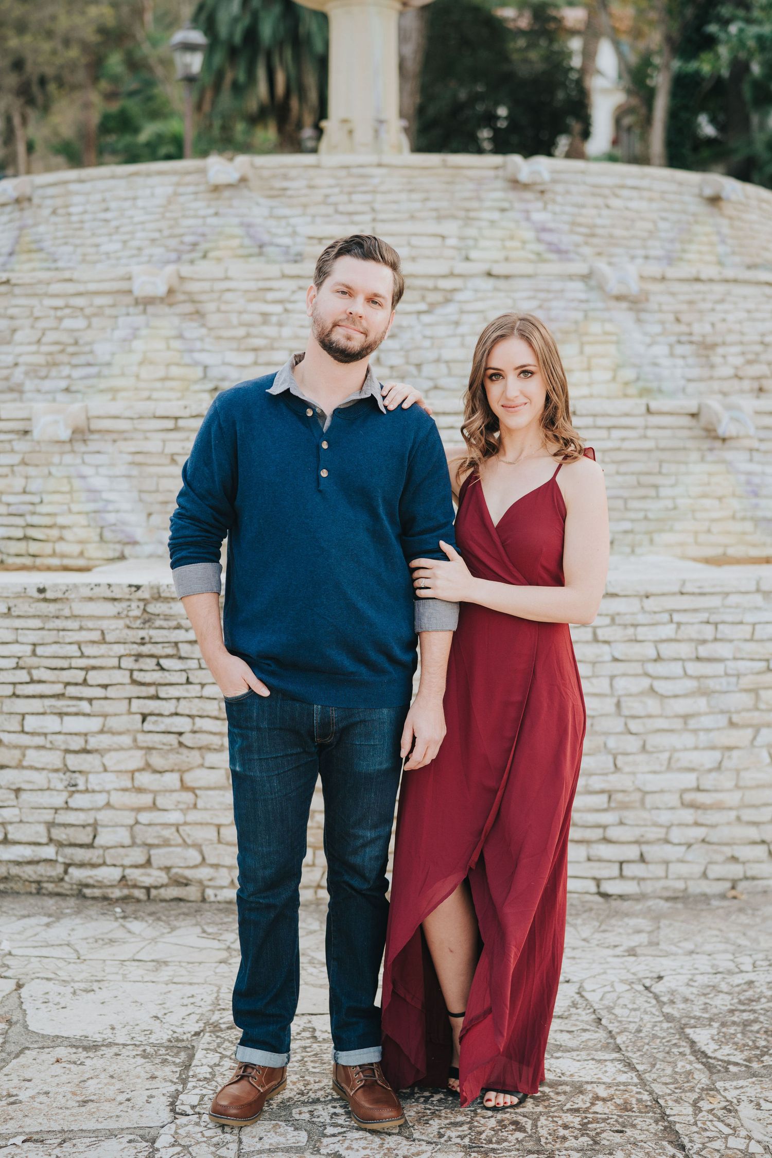 engagement photo in front of stone fountain