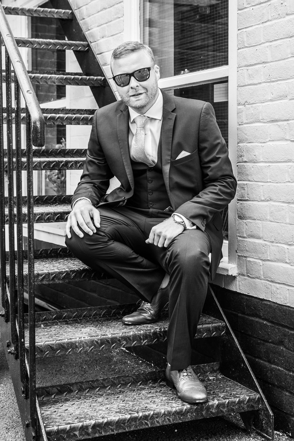 cool looking groom sitting on the stairs in black and white, Robert Nelson Wedding Photography