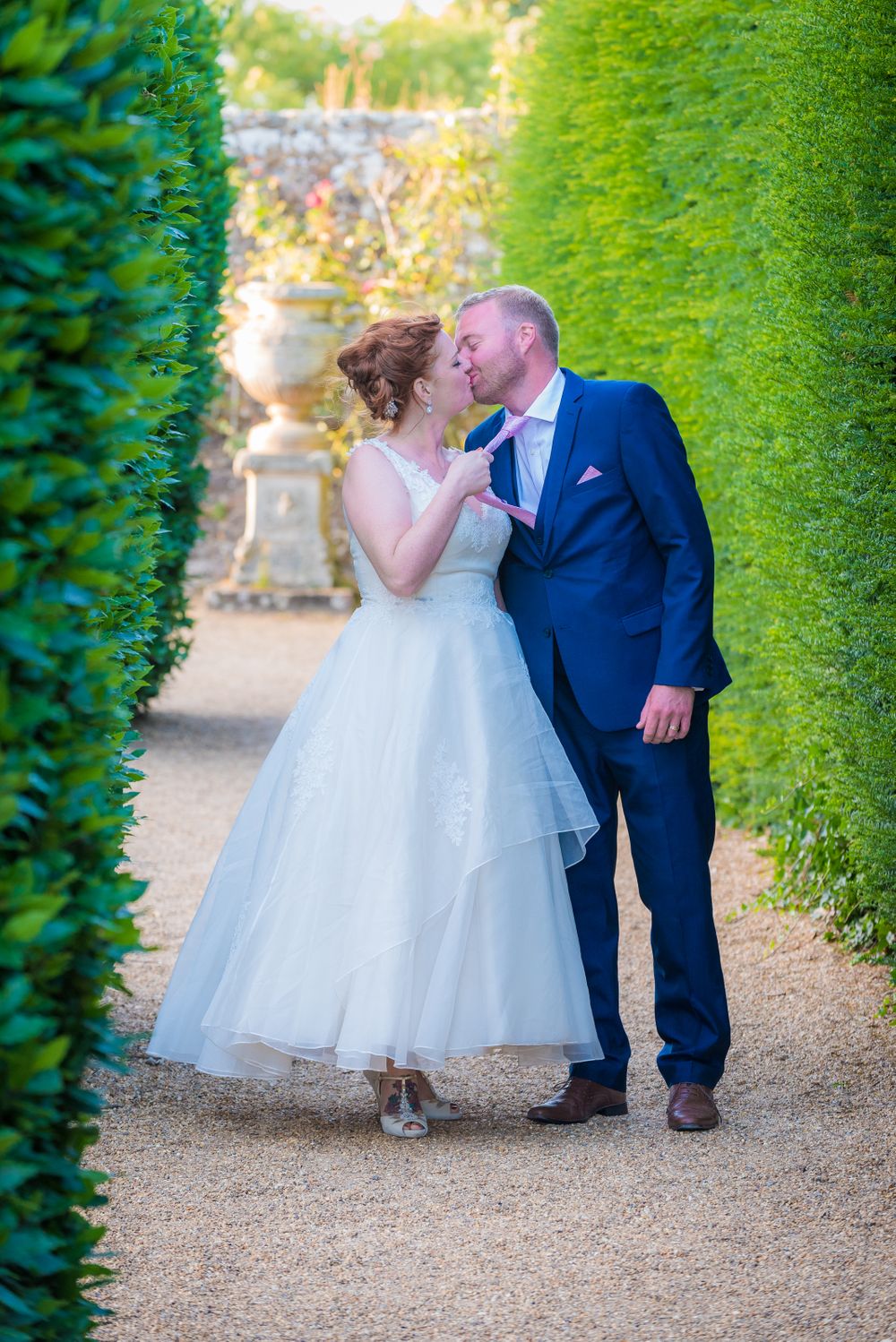 Bride pulling the grooms tie whist kissing, Robert Nelson Wedding Photography