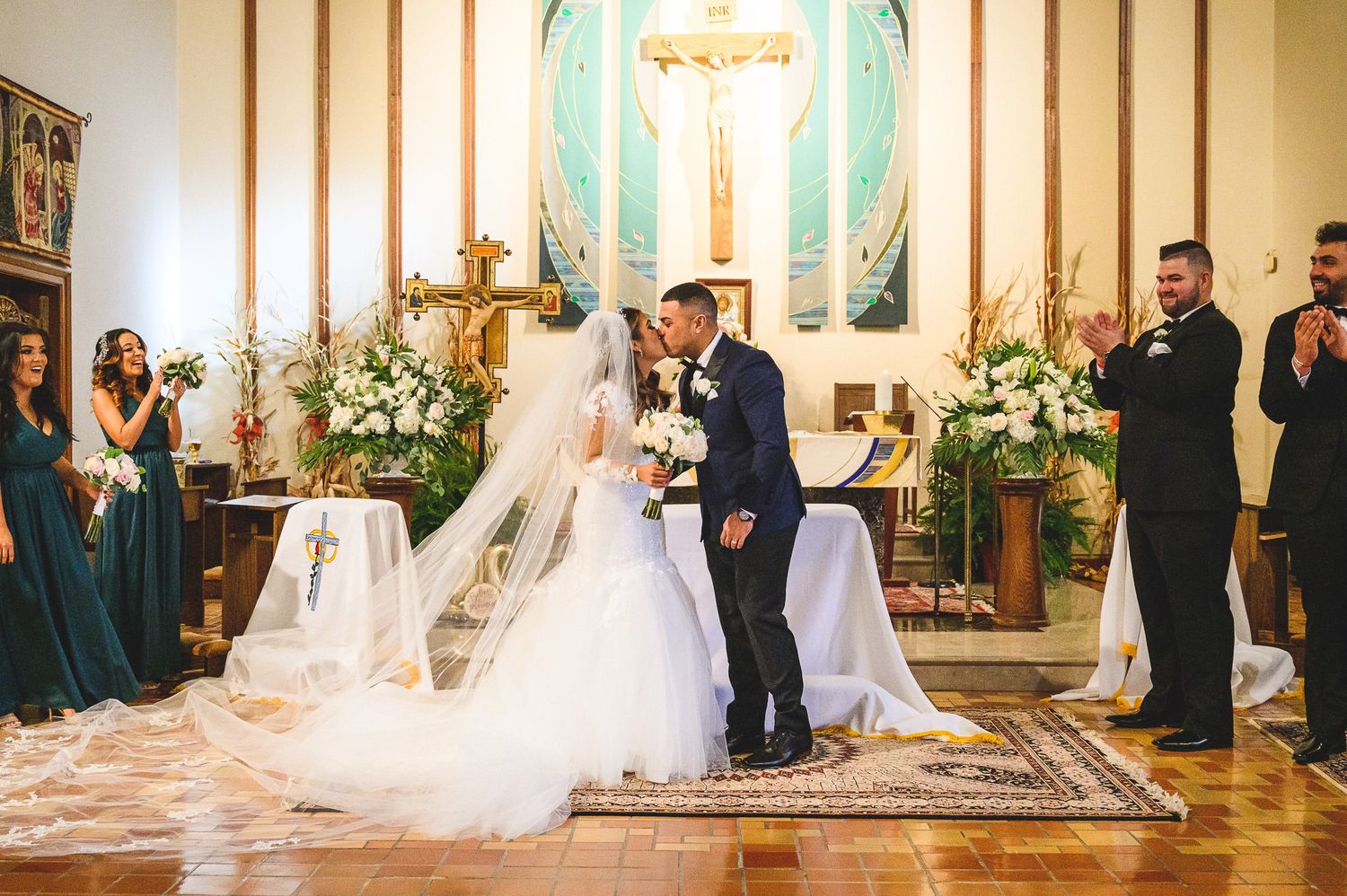 bride and groom first kiss in church